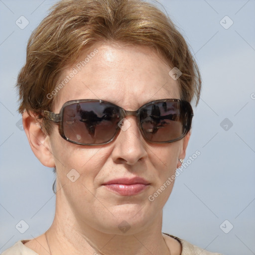 Joyful white adult female with medium  brown hair and blue eyes