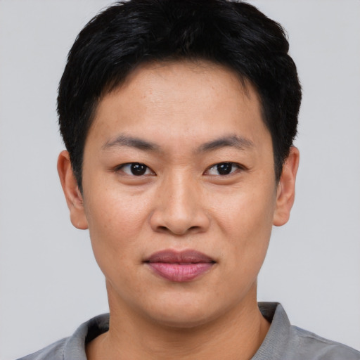 Joyful asian young-adult male with short  black hair and brown eyes