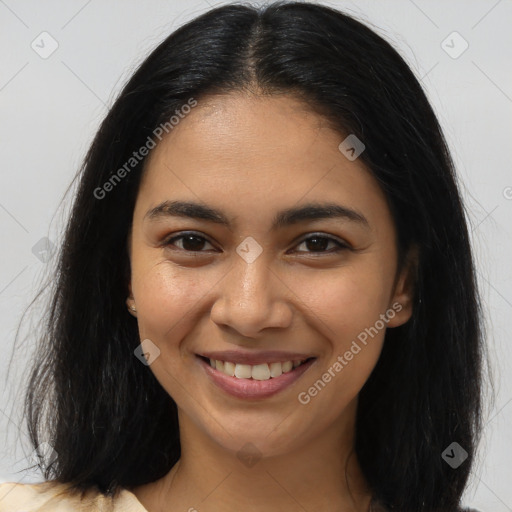 Joyful latino young-adult female with long  brown hair and brown eyes