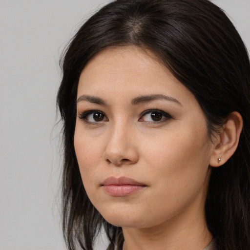 Joyful asian young-adult female with long  brown hair and brown eyes