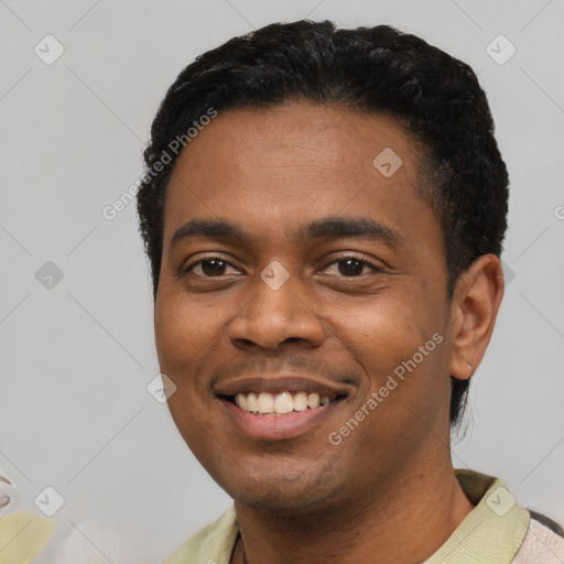 Joyful black young-adult male with short  black hair and brown eyes