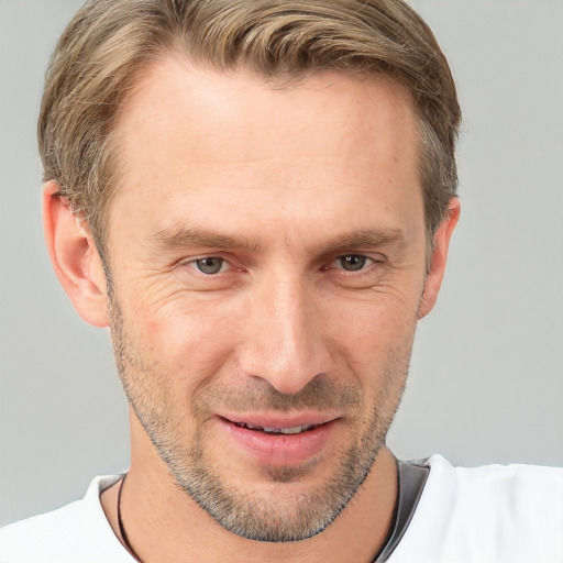 Joyful white adult male with short  brown hair and grey eyes