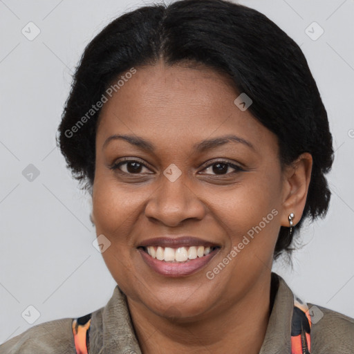 Joyful black adult female with short  brown hair and brown eyes