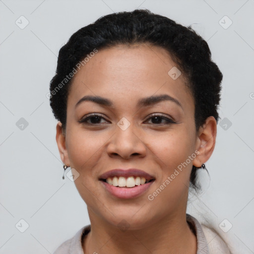 Joyful black young-adult female with short  black hair and brown eyes