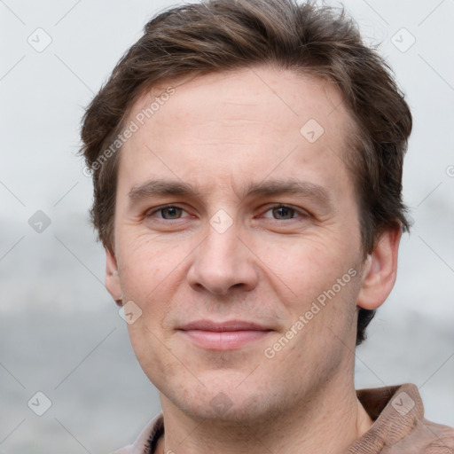 Joyful white adult male with short  brown hair and grey eyes