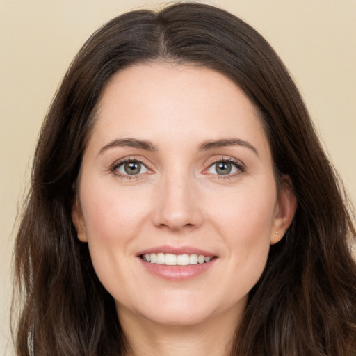 Joyful white young-adult female with long  brown hair and brown eyes