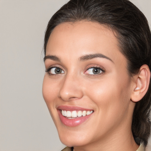 Joyful white young-adult female with medium  brown hair and brown eyes