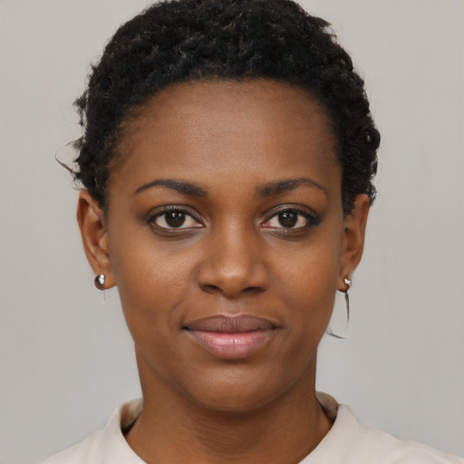 Joyful black young-adult female with short  brown hair and brown eyes