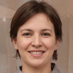 Joyful white adult female with medium  brown hair and brown eyes