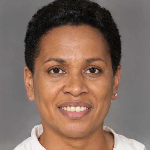 Joyful latino adult female with short  brown hair and brown eyes