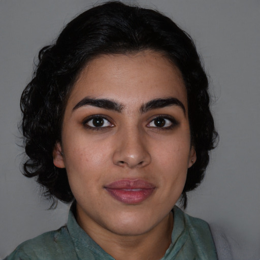 Joyful latino young-adult female with long  black hair and brown eyes
