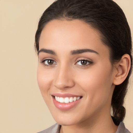 Joyful white young-adult female with medium  brown hair and brown eyes