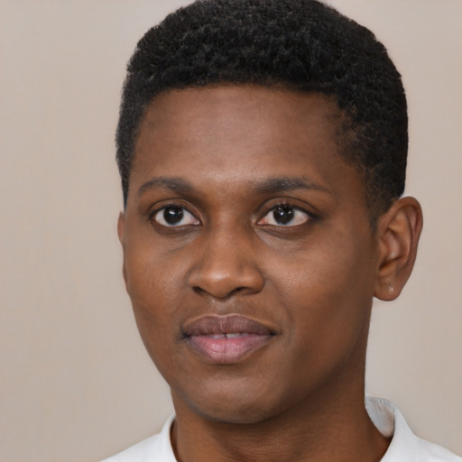 Joyful black young-adult male with short  black hair and brown eyes