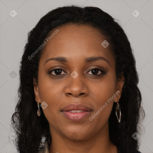 Joyful black young-adult female with long  brown hair and brown eyes