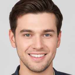 Joyful white young-adult male with short  brown hair and brown eyes