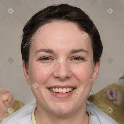 Joyful white adult female with short  brown hair and grey eyes