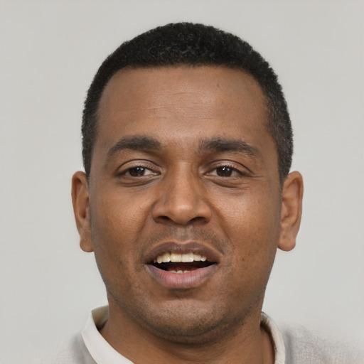 Joyful black young-adult male with short  black hair and brown eyes