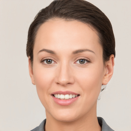 Joyful white young-adult female with short  brown hair and brown eyes