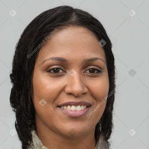 Joyful black young-adult female with long  brown hair and brown eyes
