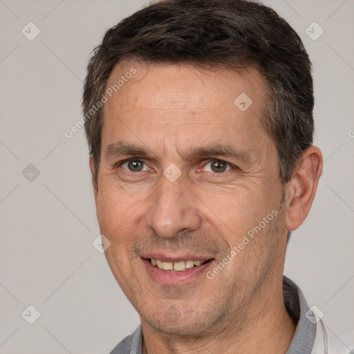 Joyful white adult male with short  brown hair and brown eyes