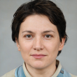 Joyful white adult female with medium  brown hair and brown eyes