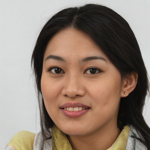 Joyful asian young-adult female with medium  brown hair and brown eyes