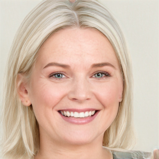 Joyful white young-adult female with medium  blond hair and blue eyes