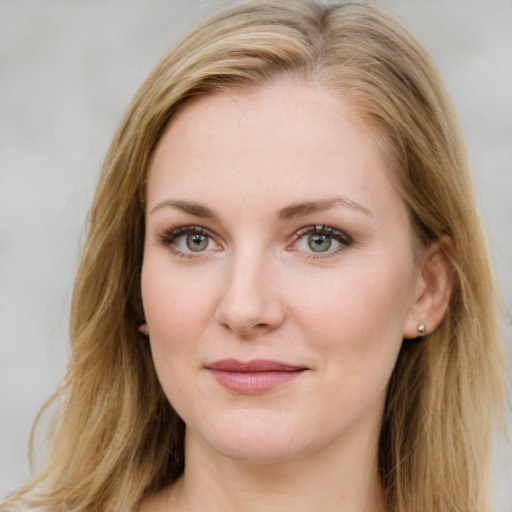 Joyful white young-adult female with long  brown hair and blue eyes