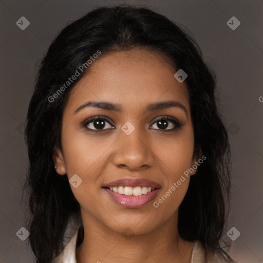 Joyful black young-adult female with long  black hair and brown eyes