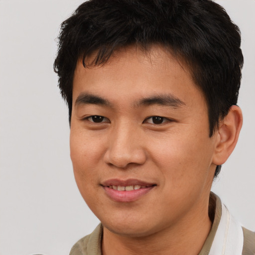 Joyful asian young-adult male with short  brown hair and brown eyes