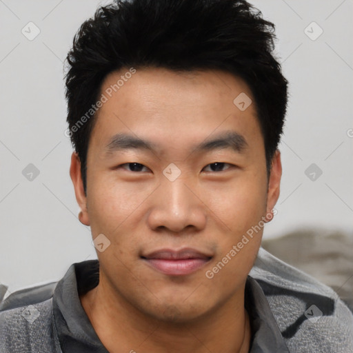 Joyful asian young-adult male with short  black hair and brown eyes