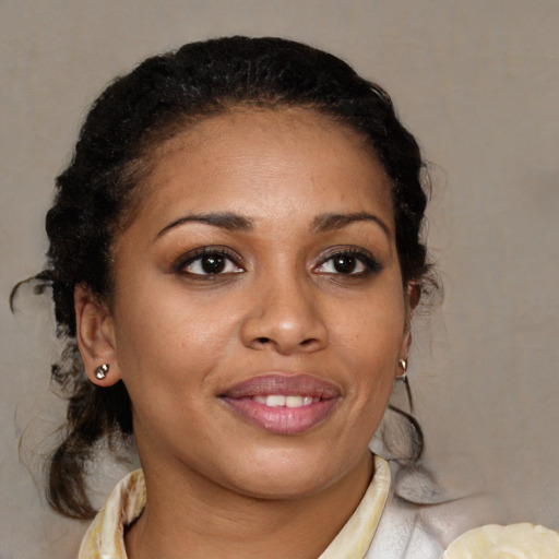 Joyful black young-adult female with medium  brown hair and brown eyes