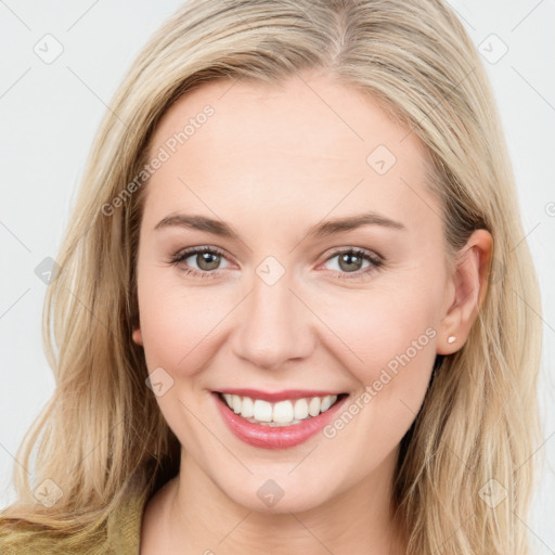 Joyful white young-adult female with long  brown hair and green eyes