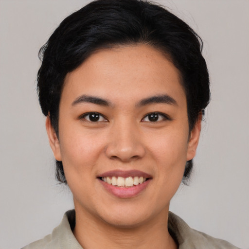 Joyful asian young-adult female with short  black hair and brown eyes