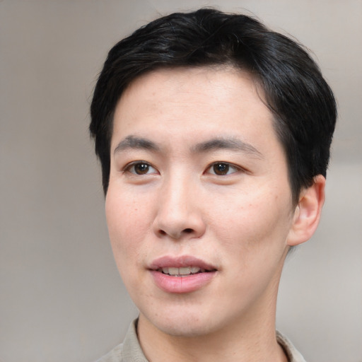 Joyful asian young-adult male with short  black hair and brown eyes