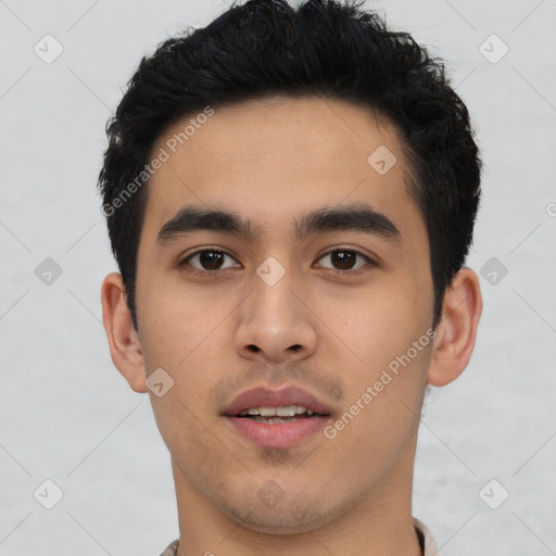 Joyful latino young-adult male with short  black hair and brown eyes