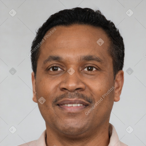 Joyful latino adult male with short  black hair and brown eyes