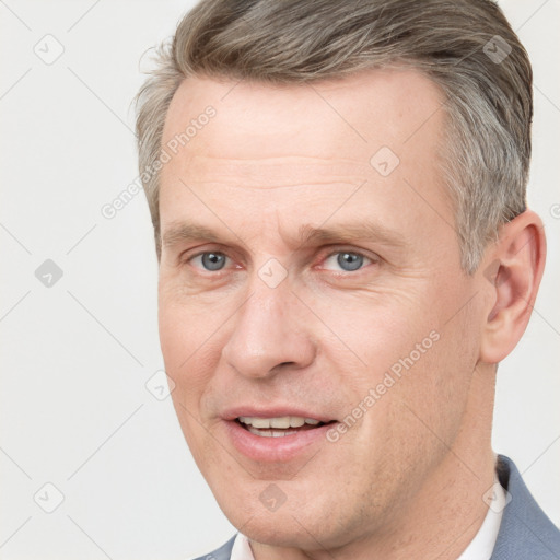 Joyful white adult male with short  brown hair and grey eyes