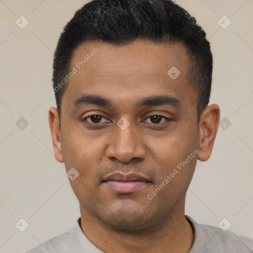 Joyful latino young-adult male with short  black hair and brown eyes