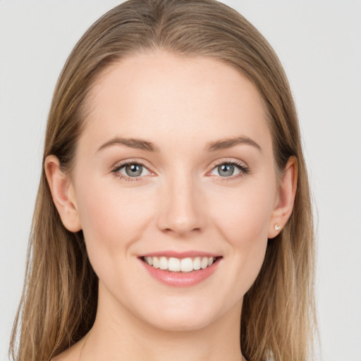 Joyful white young-adult female with long  brown hair and grey eyes