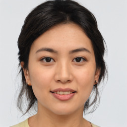 Joyful asian young-adult female with medium  brown hair and brown eyes