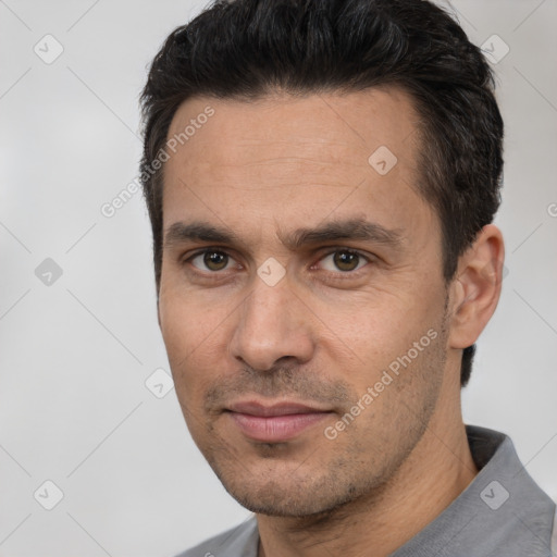 Joyful white adult male with short  black hair and brown eyes