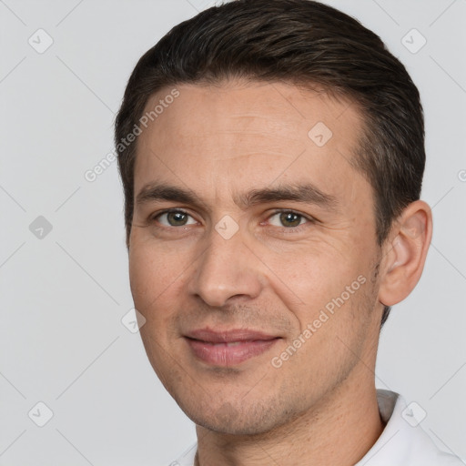 Joyful white adult male with short  brown hair and brown eyes