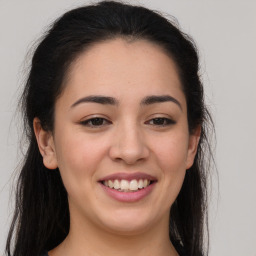 Joyful latino young-adult female with long  brown hair and brown eyes