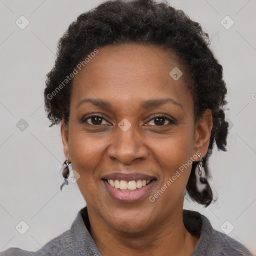 Joyful black adult female with short  brown hair and brown eyes