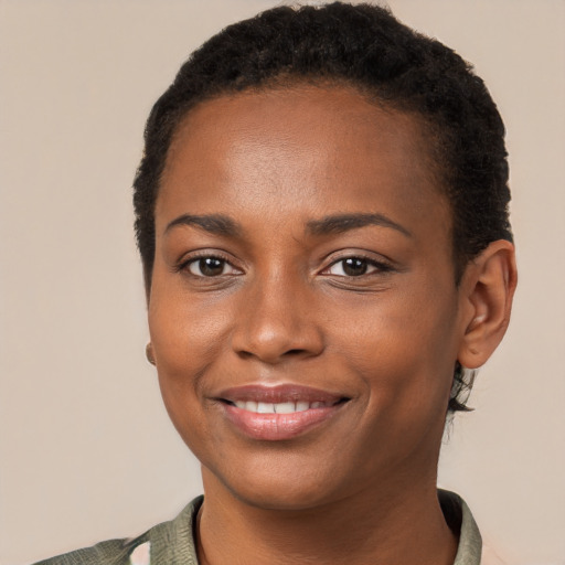 Joyful black young-adult female with short  brown hair and brown eyes