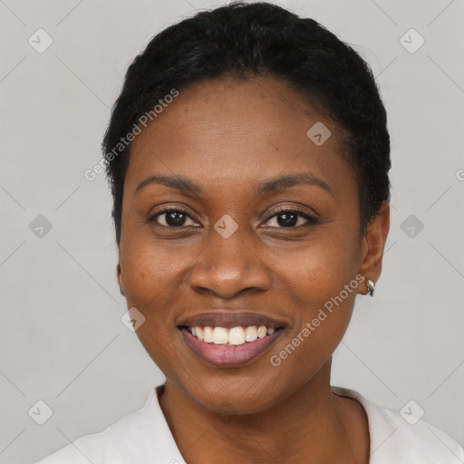 Joyful black young-adult female with short  black hair and brown eyes