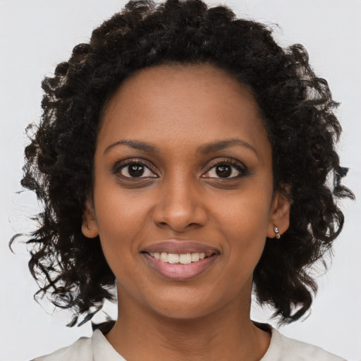 Joyful black young-adult female with medium  brown hair and brown eyes
