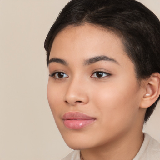 Joyful latino young-adult female with short  brown hair and brown eyes