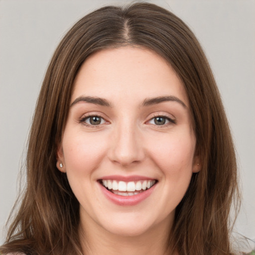 Joyful white young-adult female with long  brown hair and green eyes